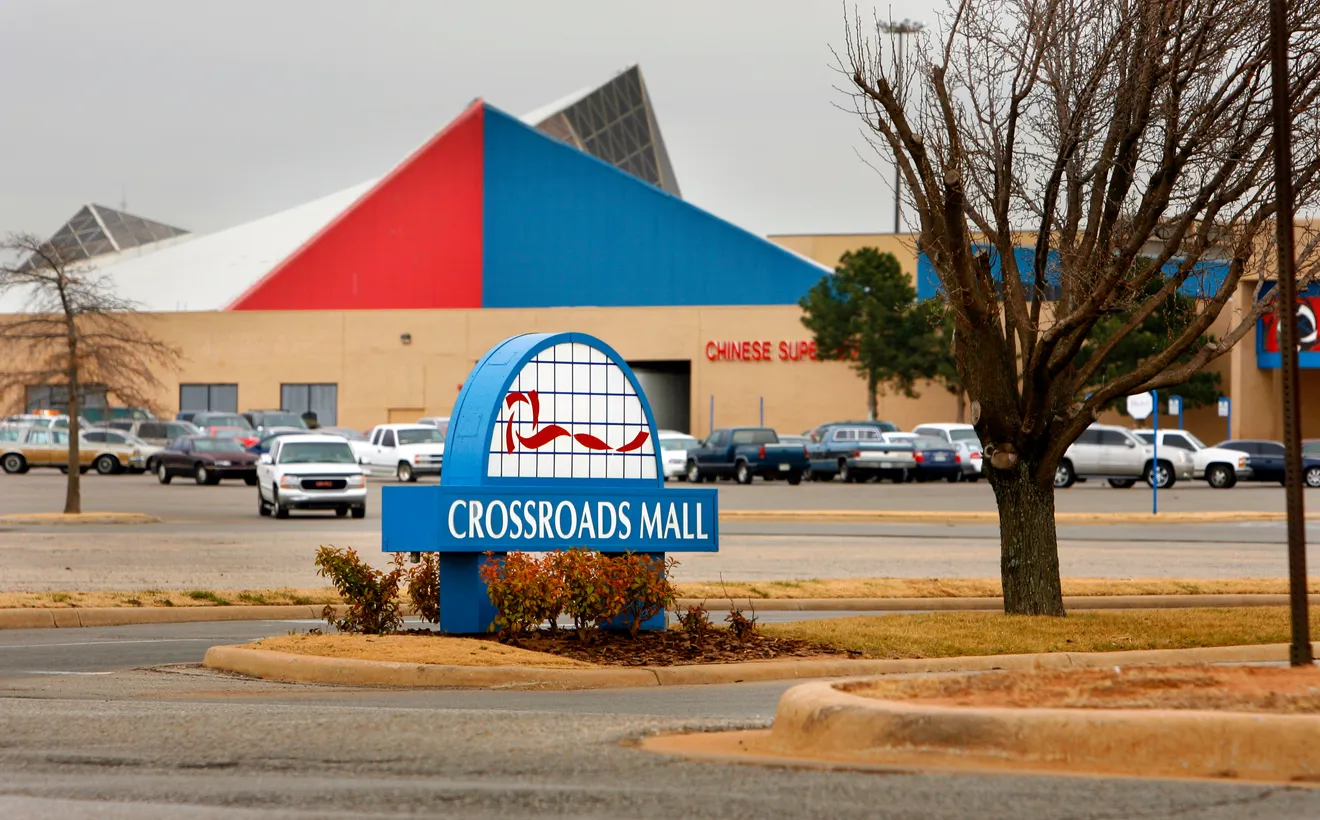 The exterior of a very 80s looking mall in Oklahoma City, complete with a red and blue geometric design